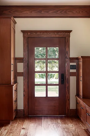 Remodeled mudroom features a solid doug. fir door with oak veneer on the exterior in HartmanBaldwin remodel.